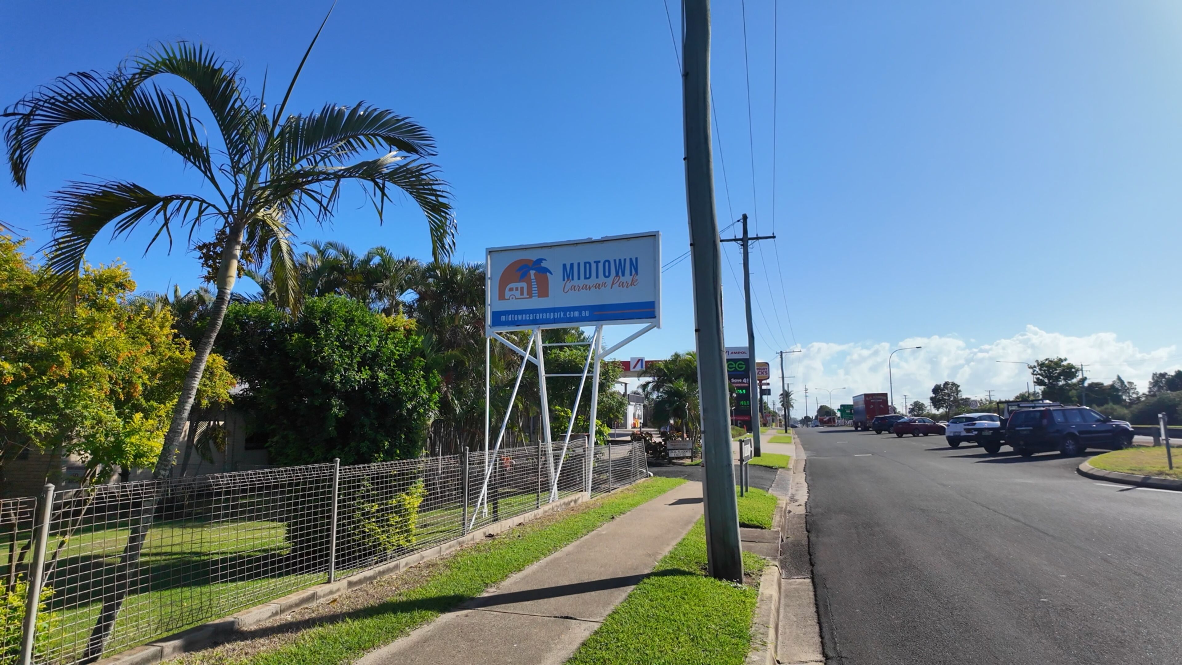 A road with a sign for Midtown Caravan Park.