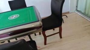 A room with a green pool table, a black chair, and a wooden floor. - Fanchang Ziyuan Express Hotel (Wuhu)