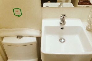 A white toilet and sink in a bathroom. - Hi Inn (Shanghai Jinqiao Yanggao Middle Road) (Shanghai)