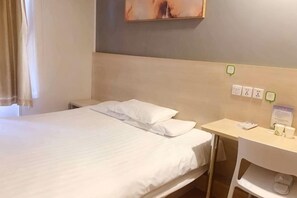 A hotel room with a bed, a desk, and a chair. There are electrical outlets and a power strip on the wall. - Hi Inn (Shanghai Jinqiao Yanggao Middle Road) (Shanghai)