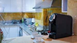 A kitchen with a microwave, toaster, and coffee maker on the counter. - Superb luxury apartment with terrace in Gueliz Marrakech (Marrakech)