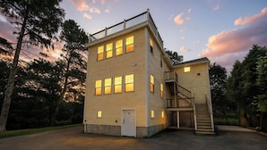 A two-story building with a balcony and a staircase leading to an upper level. - Spacious House on Sunset Lake 4 BR, 2 BA
Unit 2 on Top Floor (Braintree)