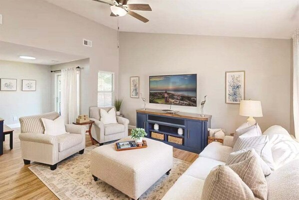 Cozy up in the stylish living room, where natural light, plush seating, and a smart TV create the perfect space for movie nights or relaxing after a day of adventure.