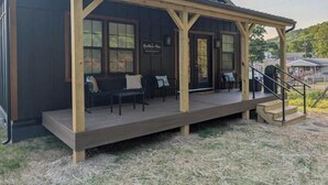 A wooden building with a covered porch, a sign reading "The Inn," and a staircase leading to the entrance. - The Hawthorne Place (Buena Vista)