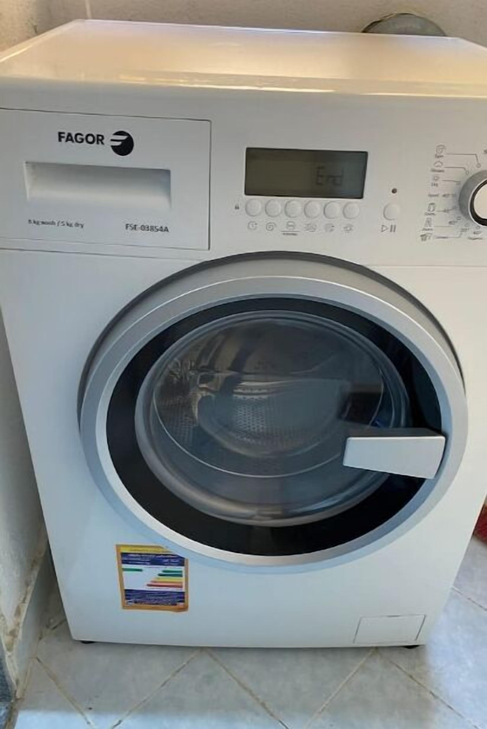 A white washing machine with a digital display and control panel.