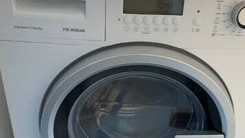 A white washing machine with a digital display and control panel.