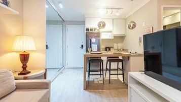 Studio Suite, City View | Living area | Flat-screen TV