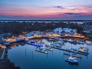 A waterfront property with multiple buildings, docks, and boats. - Monthly Rental Dream • 5BR Sea Pines Home on Lagoon | Private Heated Pool, BBQ, Bikes (Hilton Head Island)