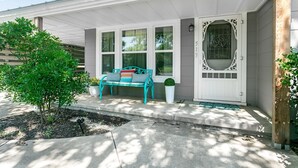 A house with a porch, a bench, and a door with a decorative window. - Golden Cottage | 2/1.5, Washer/Dryer, Full Kitchen (Fredericksburg)