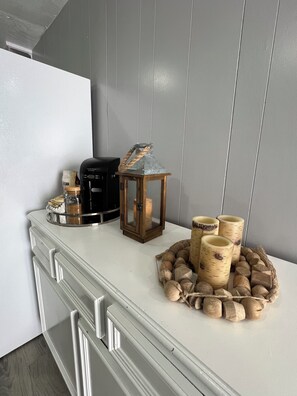 Een keukenblad met een koffiezetapparaat, een lantaarn en houten bakken.