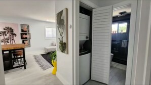 A modern living room with a dining area, a kitchen, and a bathroom. - Insta-Worthy Modern House in the Heart of Miami (Miami)
