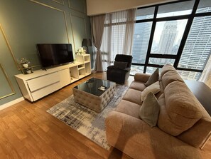 Family Studio Suite | Living room | 35-inch flat-screen TV with satellite channels - Anggun Residences KLCC by Flixses (Kuala Lumpur)
