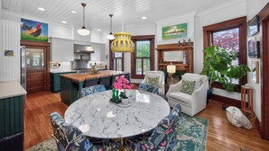 A spacious kitchen with white cabinetry, a marble island, and pendant lighting. - Walk to 5 Points • 2 Living Areas • Game Room + Gym (Nashville)