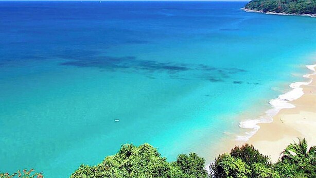 A coastal landscape with clear turquoise waters, a sandy beach, and dense green foliage. - Beachfront 120sqm 2BR With Private Plunge Pool on Stunning Naithon Beach (Sa Khu)