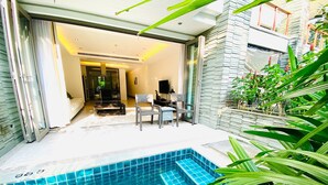 A swimming pool with a tiled edge, a seating area with chairs, and a view of the interior space. - Beachfront 120sqm 2BR With Private Plunge Pool on Stunning Naithon Beach (Sa Khu)