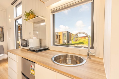Fridge, microwave, stovetop, electric kettle. Rimu View 3 by Tiny Away