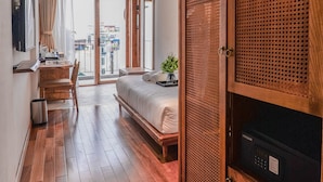 A modern hotel room with a wooden ceiling, a large sliding door, a bed, a desk, and a view of the city. - 22 Land 50 Truong Cong Giai Hotel (Hanoi)