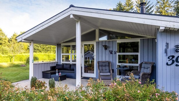 A covered outdoor seating area with a sofa, chairs, and a table. - "Dorethea" - 30km from the sea by Interhome (Toftlund)
