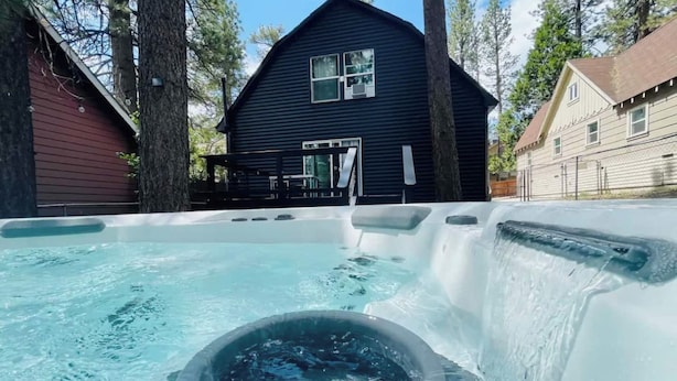 A hot tub area with a house in the background.