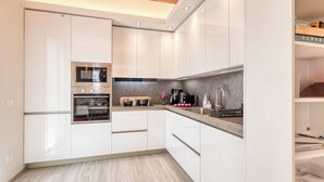 A modern kitchen with white cabinetry, a built-in oven, and a microwave. - Casa del Geco With Terrace and Parking (Sanremo)