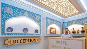 A reception area with a sign reading "RECEPTION" and "HOTEL GRAND VIZIR". - Grand Vizir hotel (Khiva)