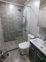 Shower, hair dryer, slippers, towels