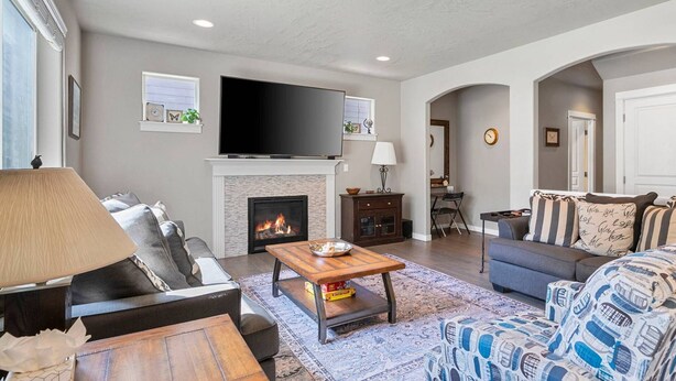 A living room with a fireplace, a flat-screen TV, and a sofa. - Fantastic High Desert Retreat, Pet Friendly, Fenced Backyard w/ Covered Patio, Ping Pong, BBQ (Bend)