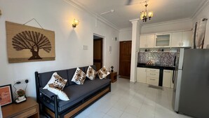 A modern apartment with a living room, kitchen, and dining area. - 1bhk flat with pool view 5 mins walk to Candolim beach in a prime location. (Calangute)