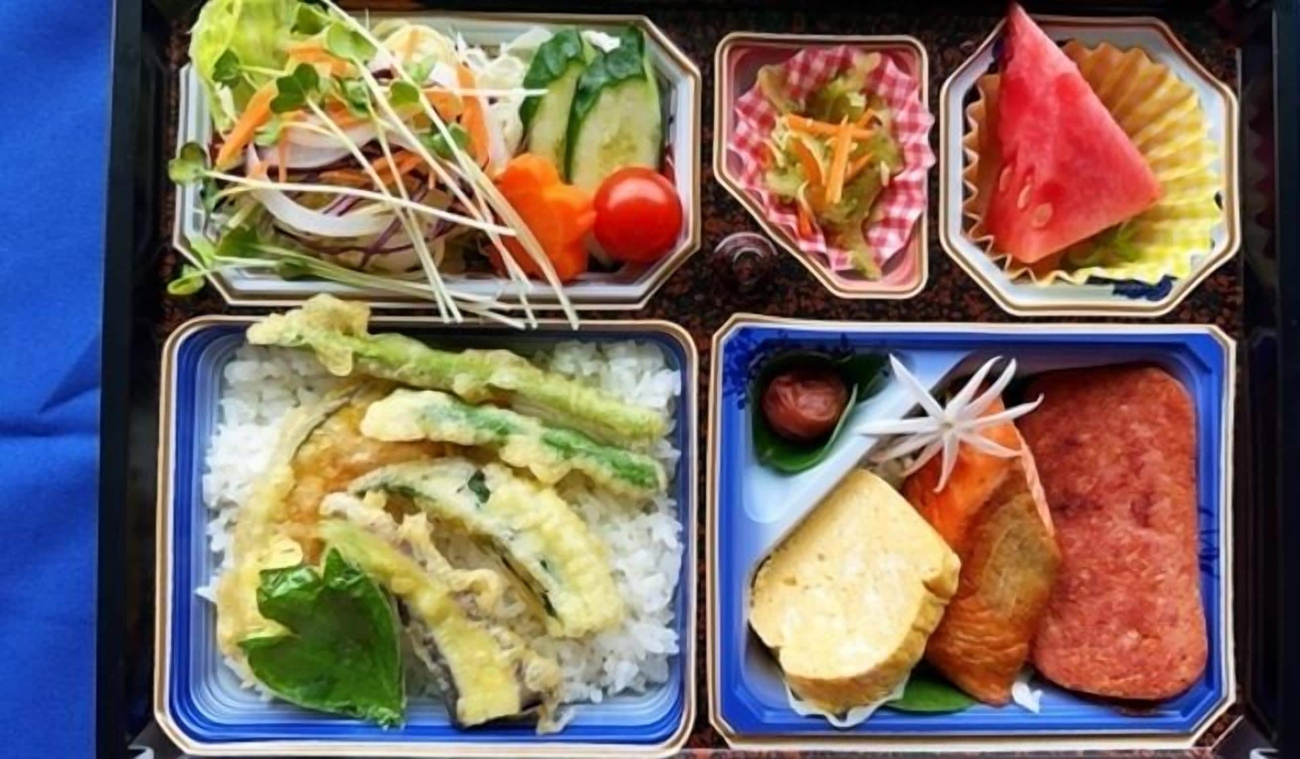 A bento box with rice, vegetables, and protein.