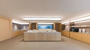 A modern, well-lit restroom with a central sink area, wooden cabinets, and a large mirror. - Full Season Hotel-HGH (Hangzhou)
