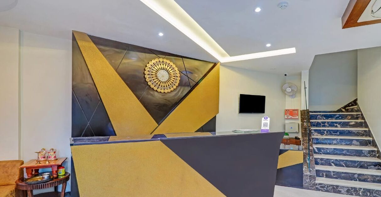 A reception area with a modern design, including a geometric wall pattern and a central decorative element.