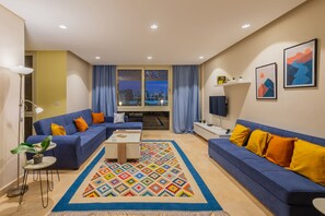 Apartment | Living area | 55-inch Smart TV with cable channels, streaming services - Xuru Stays I Sparky & Summery 2 BDR @ Mangroovy Free Beach & Pool Access (El Gouna)
