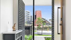 A modern apartment with a view of a brick building and a street.
