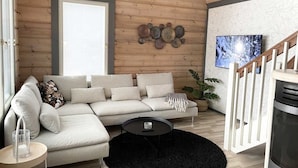 Een moderne woonkamer met een hoekbank, een ronde salontafel en een groot raam.
