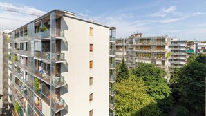 A modern multi-story residential building with balconies, large windows, and a clear view of the surrounding area. - notaMi - Simply Six (Milan)