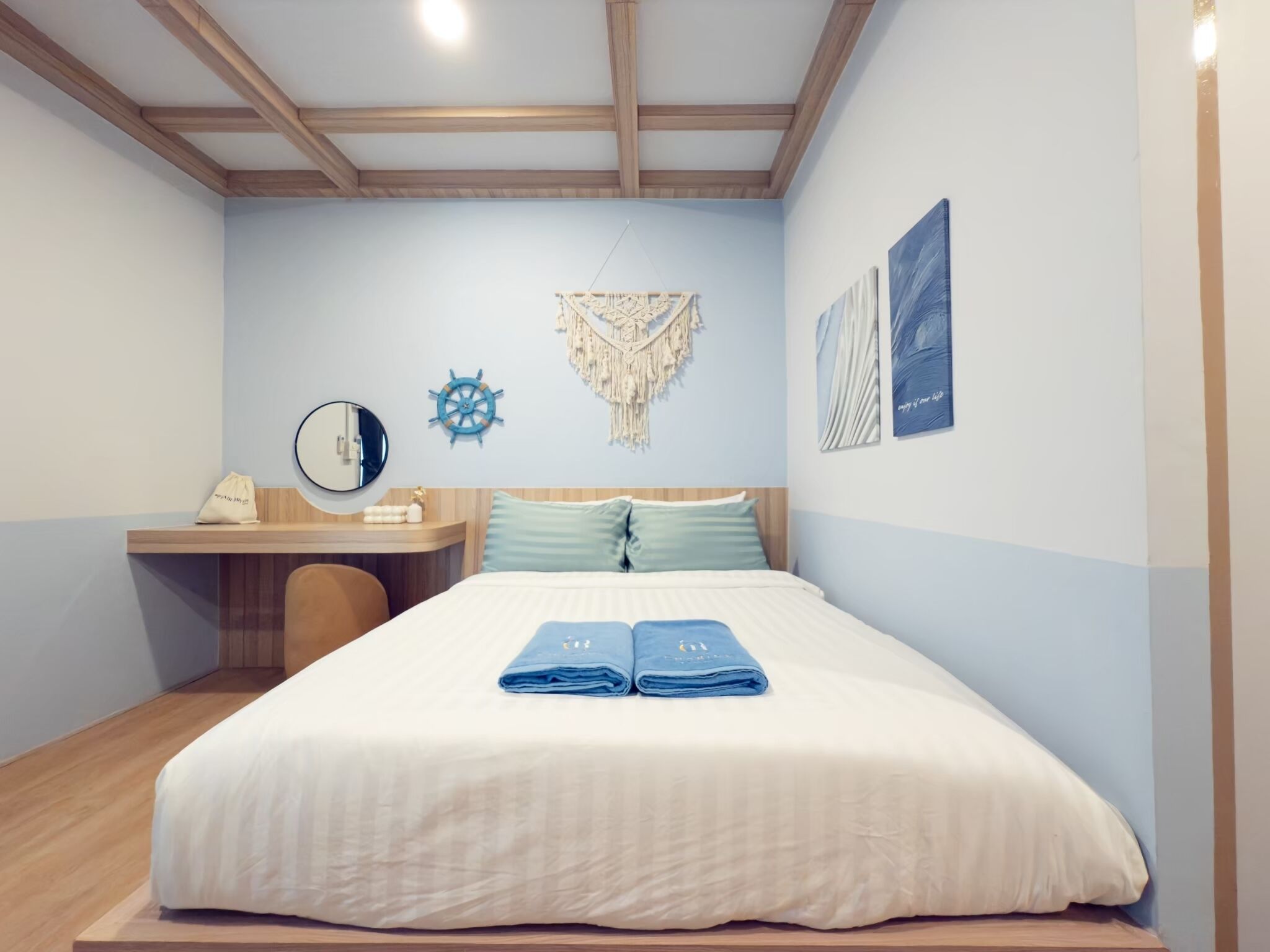 A neatly arranged bedroom with a bed, a desk, and a chair.
