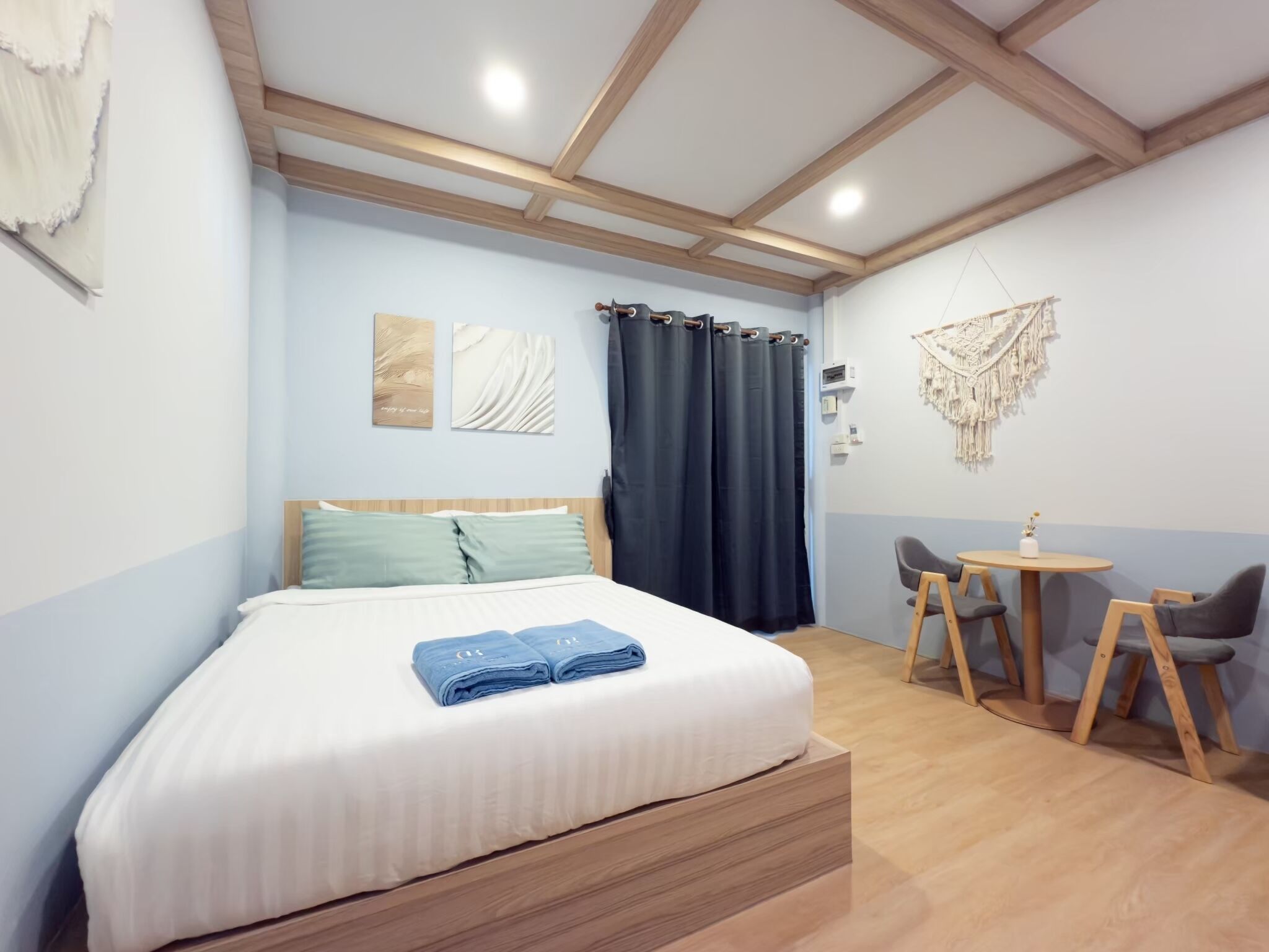 A bedroom with a bed, a desk, and a chair.