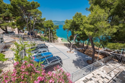 Beachfront One-Bedroom Apartment with Sea View & Pool