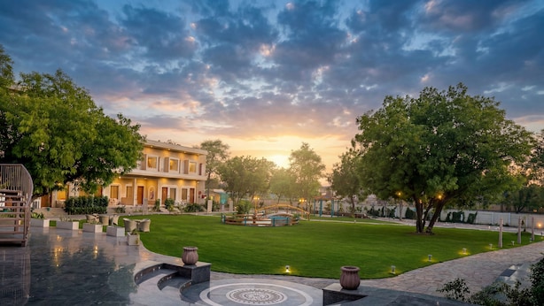A courtyard with a fountain, a gazebo, and a well-maintained lawn. - Kadamb Kuteer Vrindavan (Mathura)
