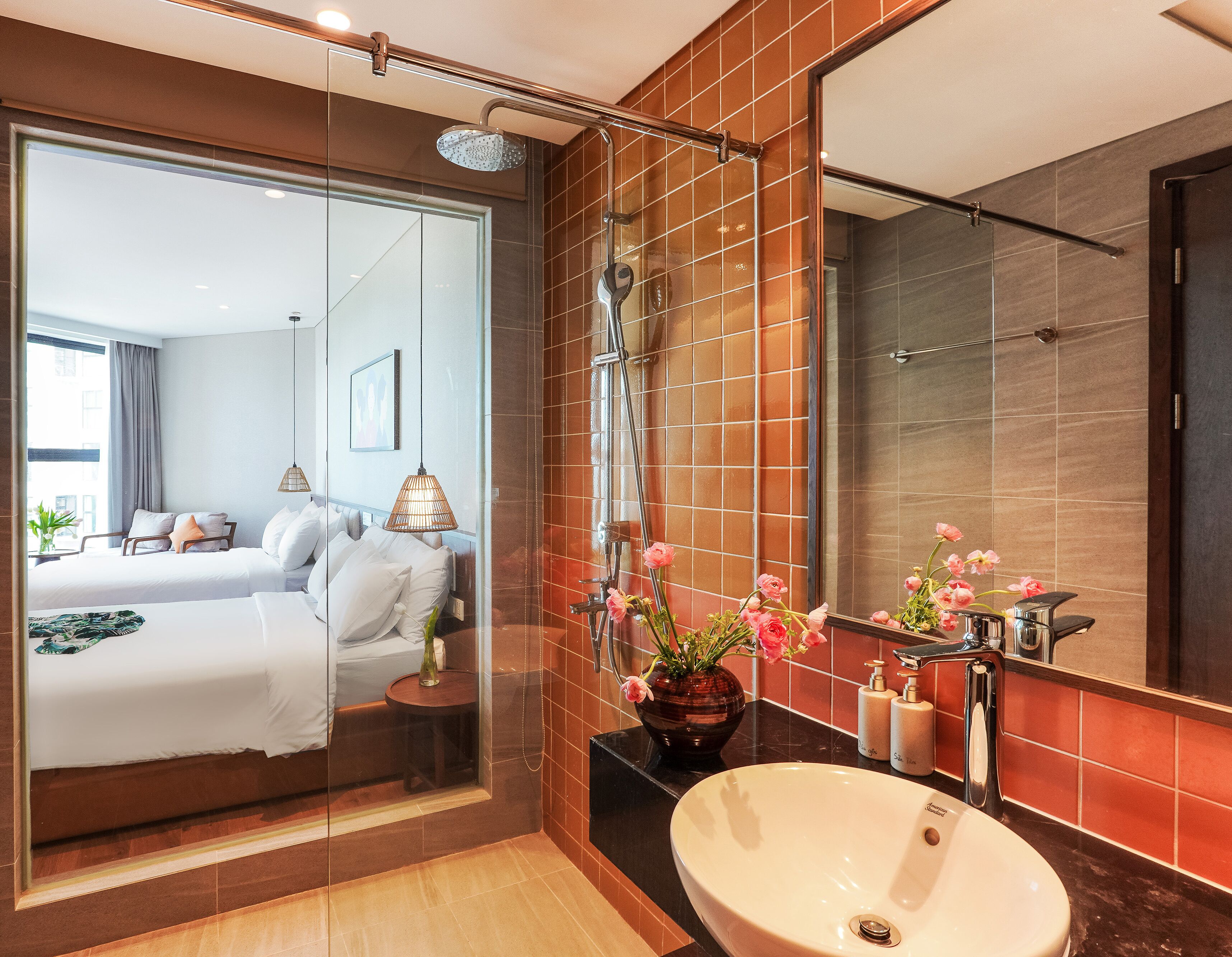 A modern bathroom with a large mirror, a sink, and a shower.