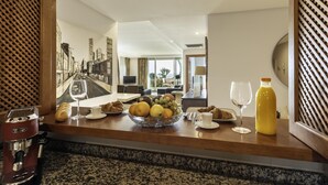 A breakfast setup with croissants, fruit, and a coffee machine. - Luxury beachfront apartment in Estepona (Estepona)