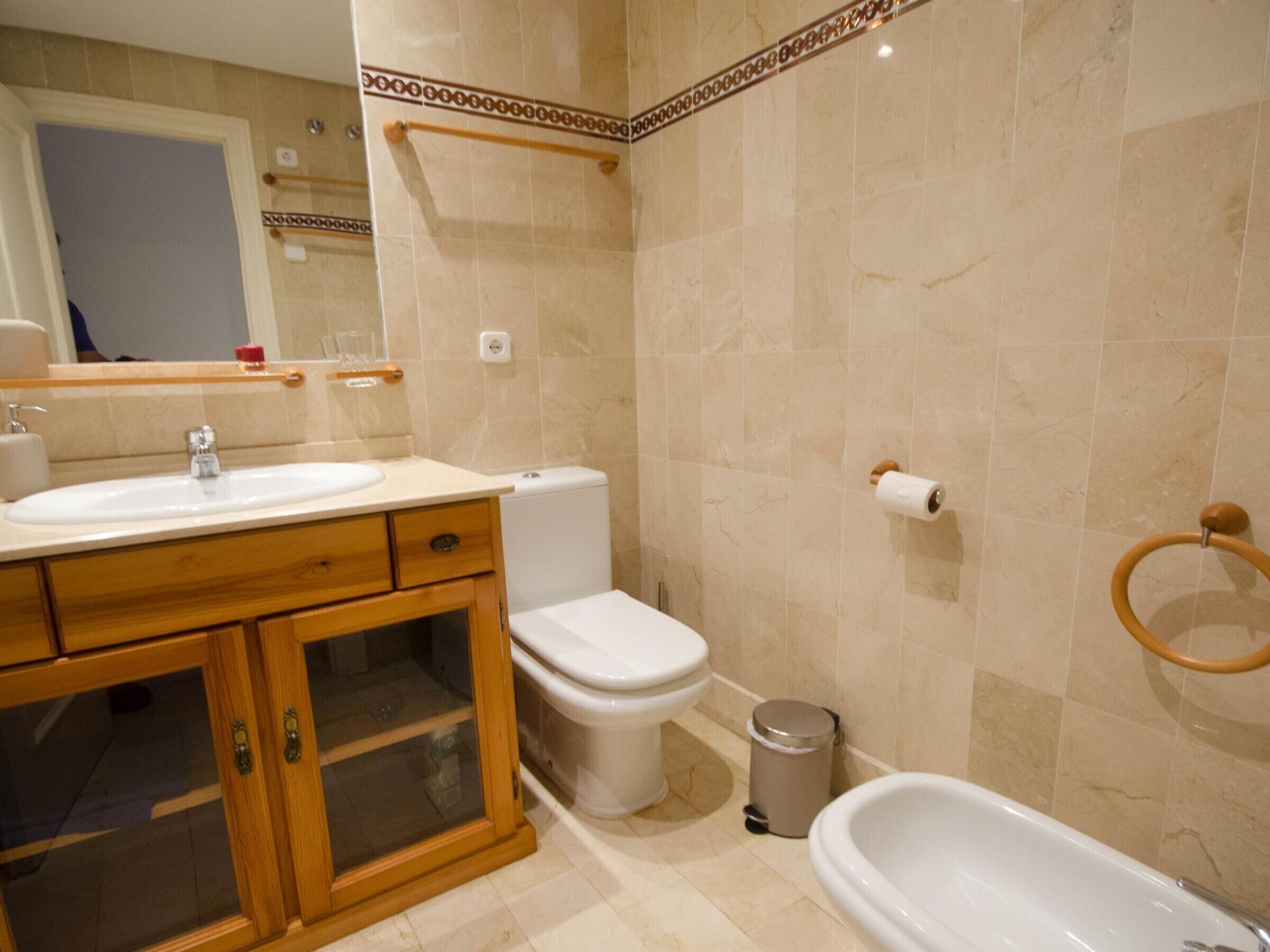 A bathroom with a sink, toilet, and bathtub.