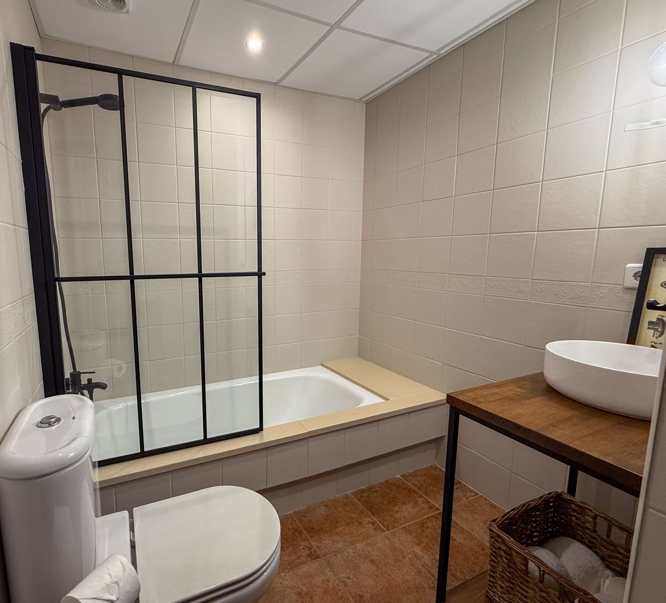 A bathroom with a bathtub, toilet, and sink.