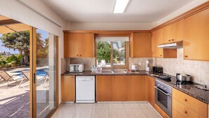 A modern kitchen with wooden cabinets, a built-in oven, and a dishwasher.