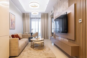 Deluxe Apartment, Balcony, City View | Living area | 50-cm Smart TV with cable channels - Keyrock Living - Stylish Dubai Stay (Dubai)