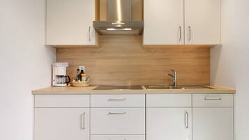 Fridge, stovetop, dishwasher, coffee/tea maker