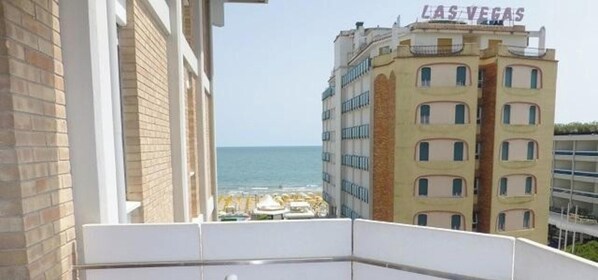 A hotel with a view of the ocean and a beach.