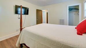 A bedroom with a bed, a television mounted on the wall, and a closet with a window. - 5 Mi to Uptown: Charlotte Hideaway w/ Yard (Charlotte)