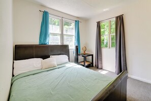 A bedroom with a bed, a bedside table, and a window with curtains. - 2 Mi to Center City: Charlotte North End Home (Charlotte)