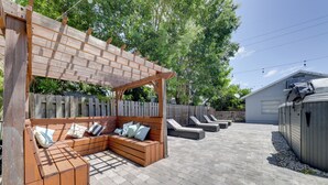 A wooden deck with a built-in bench and a pergola, surrounded by a wooden fence and trees. - 3 Mi to Beach: Home w/ Outdoor Space in Hollywood (Hollywood)